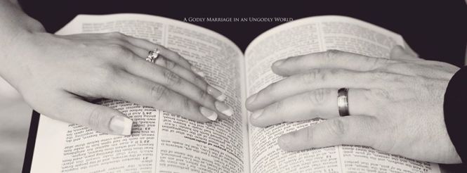 wife and husbands hand on Bible 2017